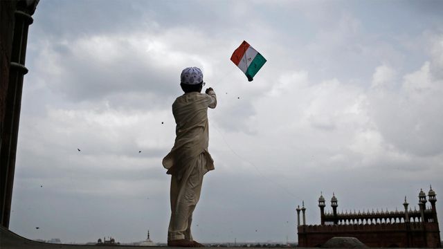 A boy flies a tricoloured kite at Jama Masjid, Delhi