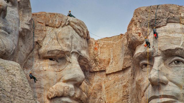 Park service employees inspecting Mount Rushmore National Memorial, South Dakota