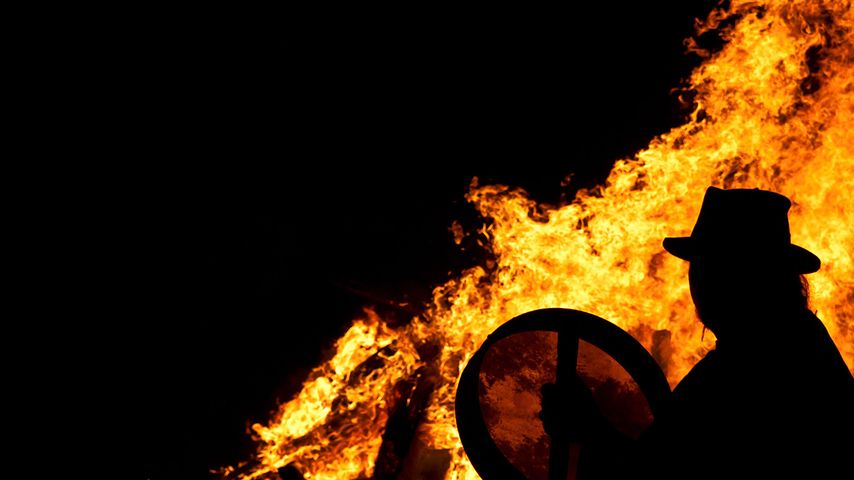 Drummer with a bodhran at a pagan Beltane fire ceremony