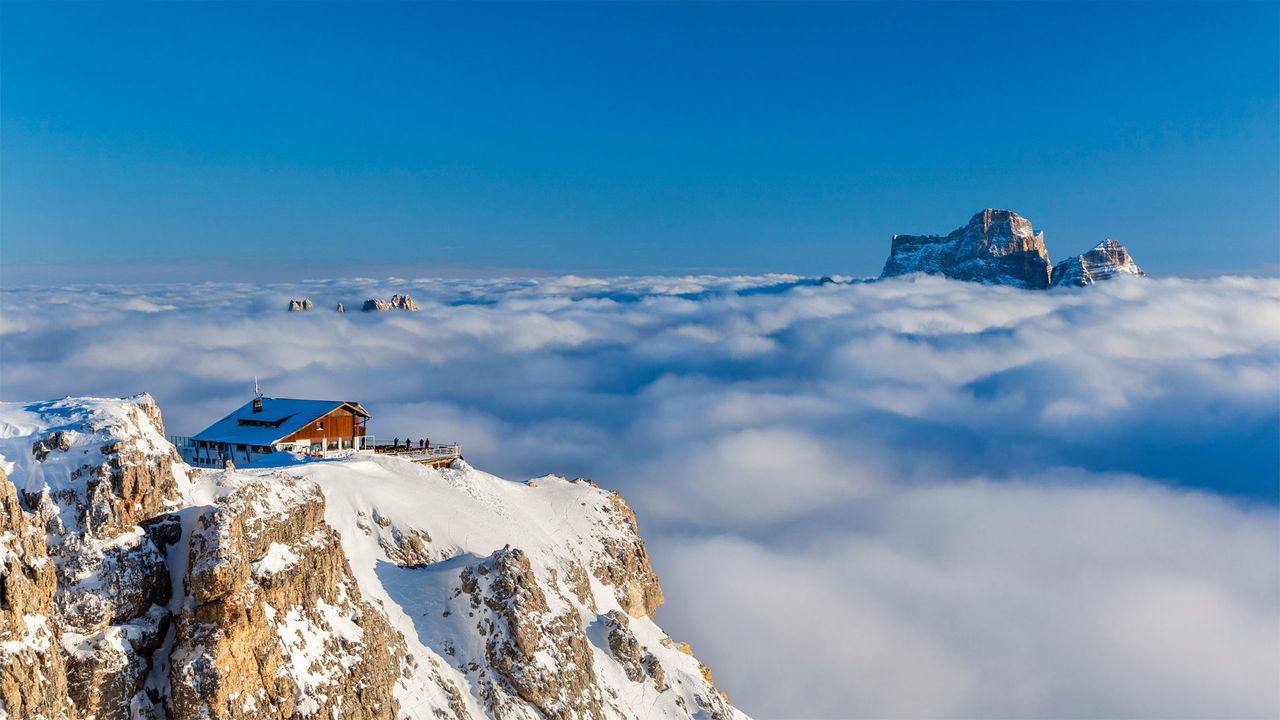 Rifugio Lagazuoi above the clouds with Monte Pelmo in the background, Dolomites, Italy