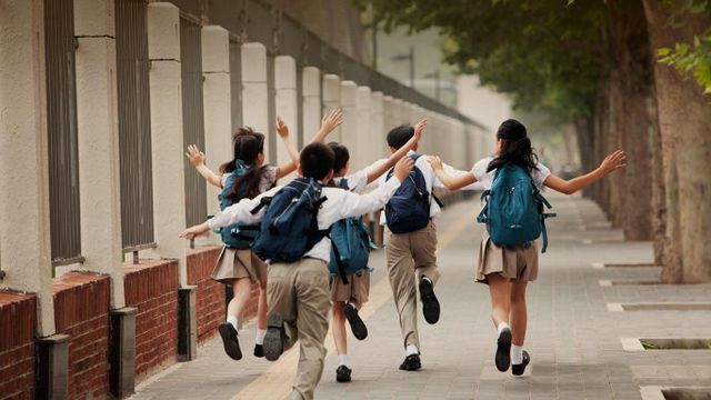 上学路上，身穿校服的学生的背影