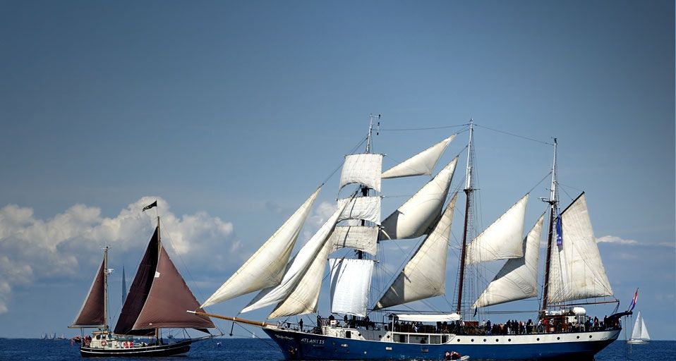 Kleines Segelboot trifft auf eine dreimastige Barkentine während der Kieler Woche 2010, Schleswig-Holstein, Deutschland – Michael Dietrich/Imagebroker RF/Photolibrary ©