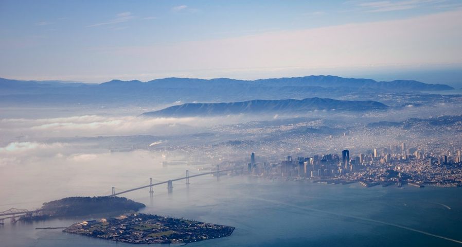 Aerial view of Yerba Buena and Treasure islands, Oakland Bay Bridge, and San Francisco, California