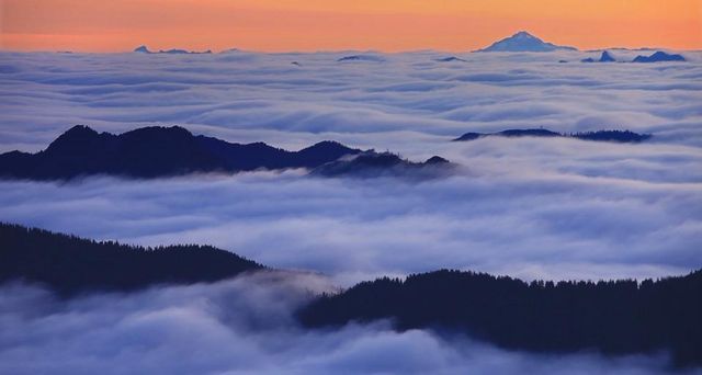 Fog over Spray Park in Mount Rainier National Park with Glacier Peak in the background, Washington, USA
