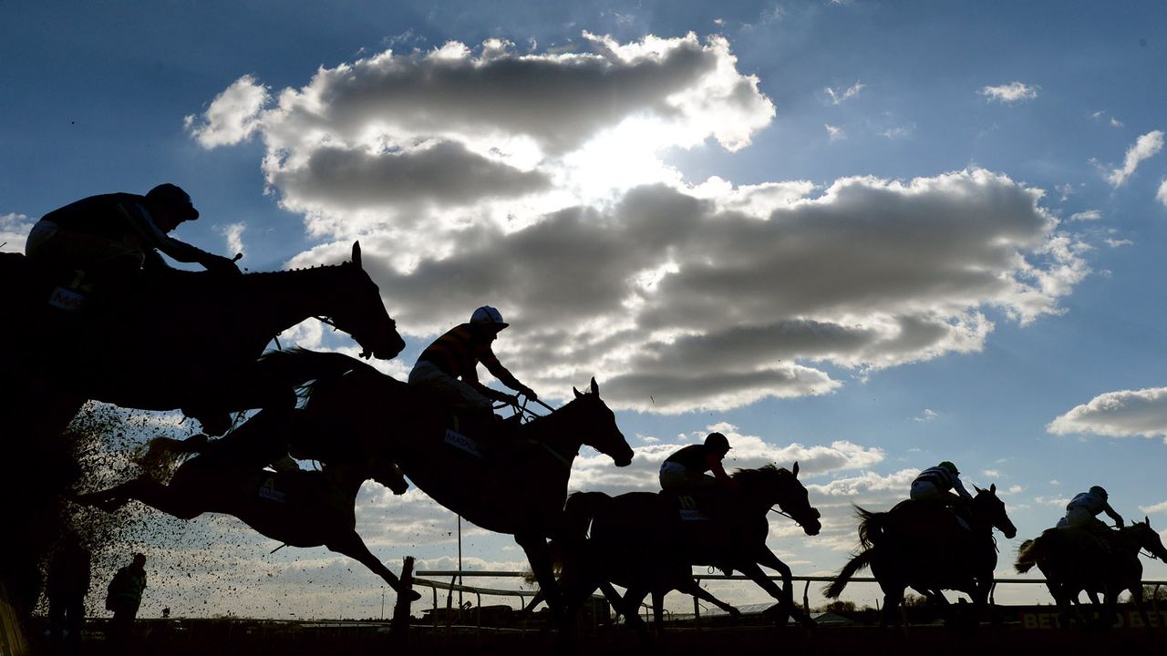 Riders and horses compete at Aintree Racecourse 