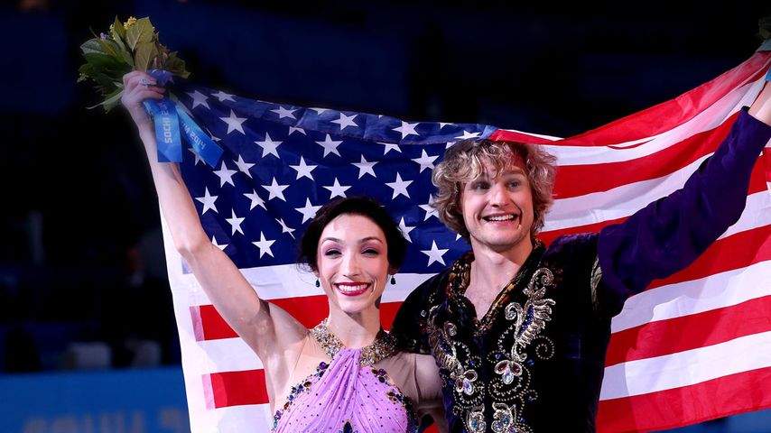 Gold medalists Meryl Davis and Charlie White of the United States celebrate during the flower ceremony for Figure Skating Ice Dance at the 2014 Winter Olympics, February 17, 2014, Sochi, Russia
