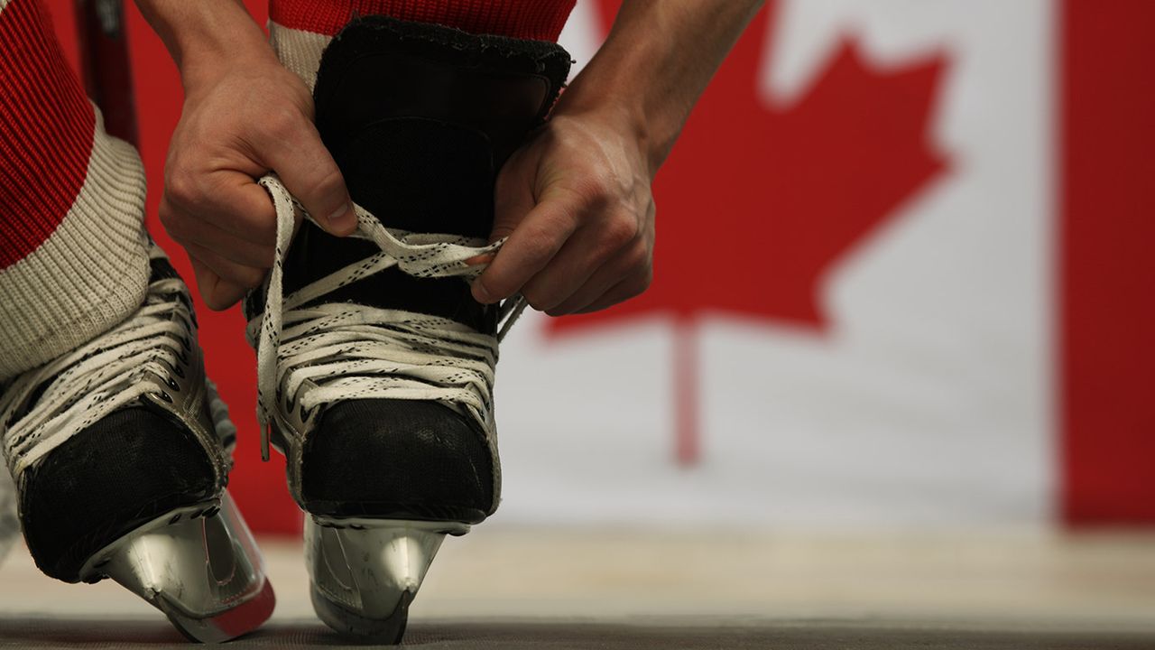 Man lacing skates 