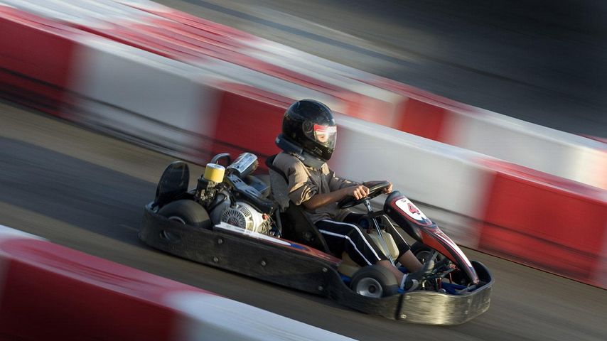 Go-kart racing on a track, side view