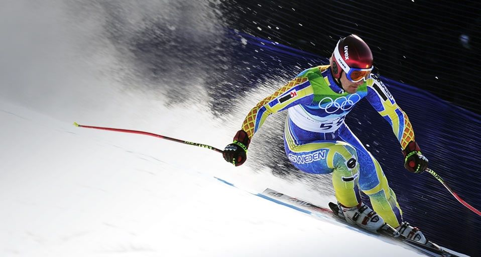 Tajikistan's Andrey Drygin, wearing an old Swedish team ski outfit, clears a gate during the Men's Super-G race at the Vancouver 2010 Winter Olympics on 19 February 2010 – Fabrice Coffrini/AFP/Getty Images ©