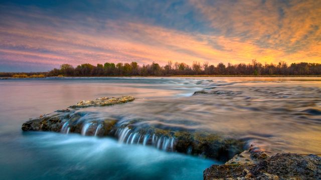 River flowing over rocks at twilight, Coteau-du-Lac, Que. 