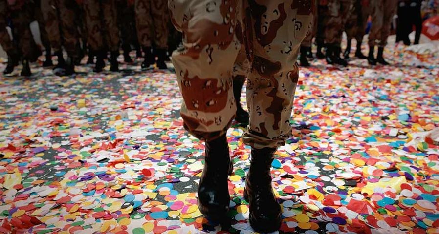 Solider walking in confetti after a parade