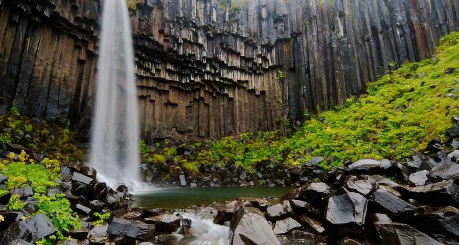 Svartifoss waterfall flanked by hexagonal basalt columns in Vatnajökull National Park, Iceland
