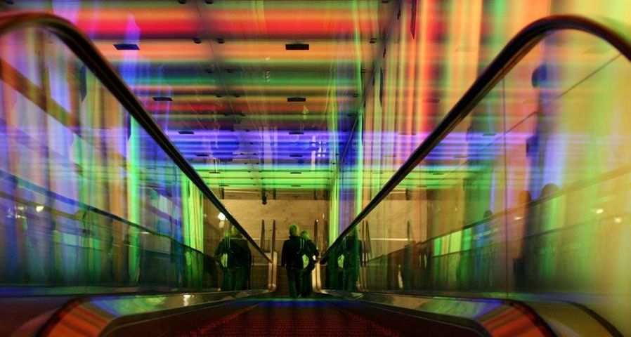 Escalator through the “Tunnel of Light” installation at the Nydalen Metro Station in Oslo, Norway
