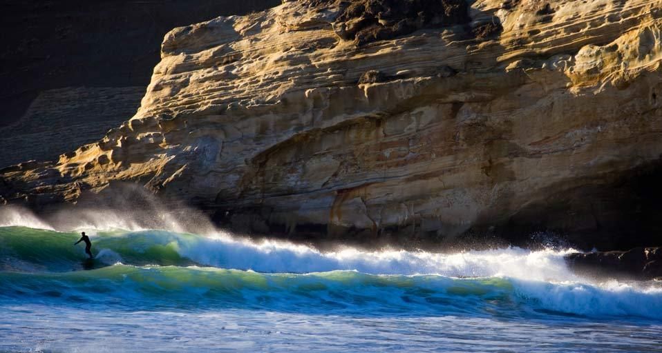Surfer riding a wave near Pacific City, Oregon