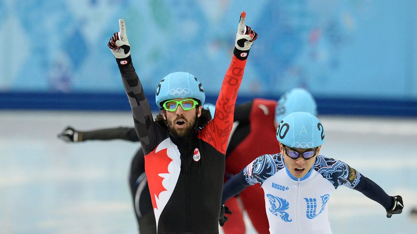 Canada's Charles Hamelin (L) celebrates after winning the gold medal in the Men's Short Track 1500 m Final at the Iceberg Skating Palace during the Sochi Winter Olympics on February 10, 2014