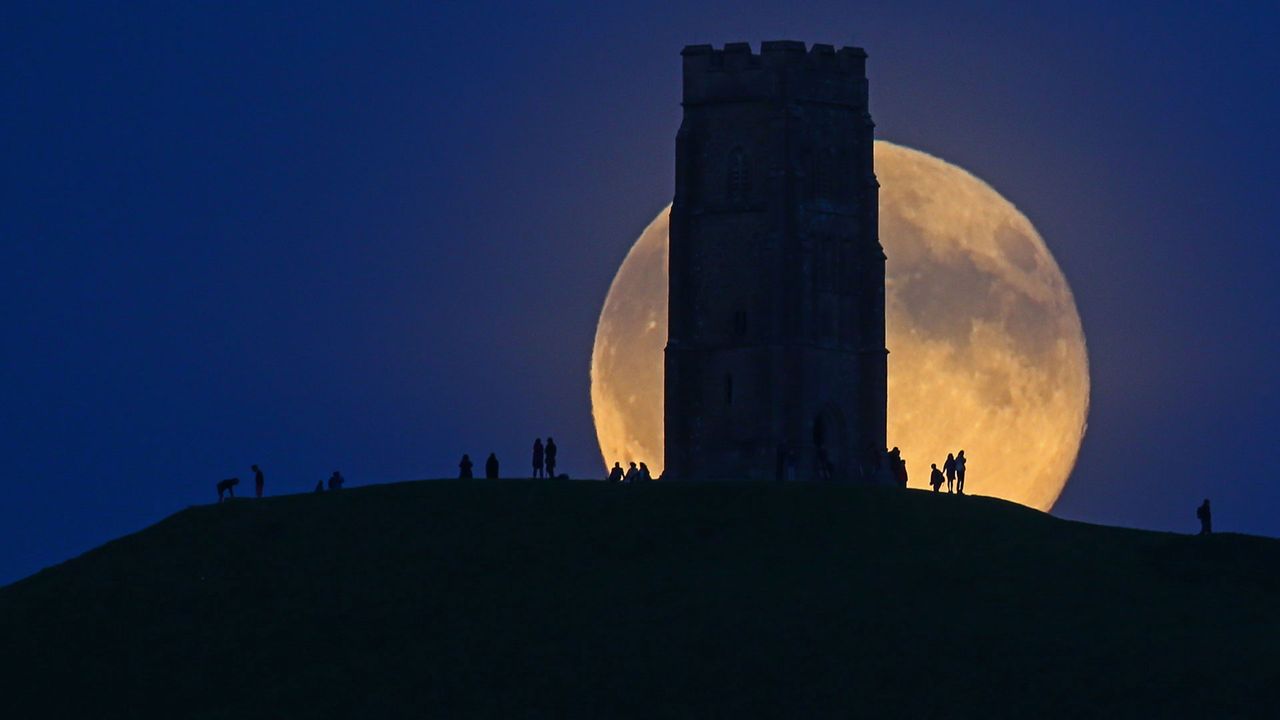 The moon rises over Glastonbury Tor, England 