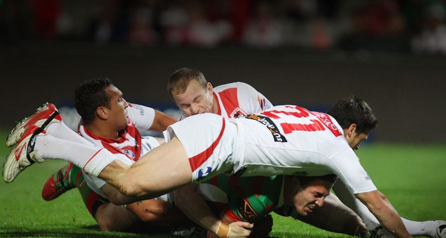 NRL Rd 26 - Dragons v Rabbitohs/SYDNEY, AUSTRALIA - SEPTEMBER 05: Sam Burgess of the Rabbitohs is tackled during the match between the St George Illawarra Dragons and the South Sydney Rabbitohs at WIN