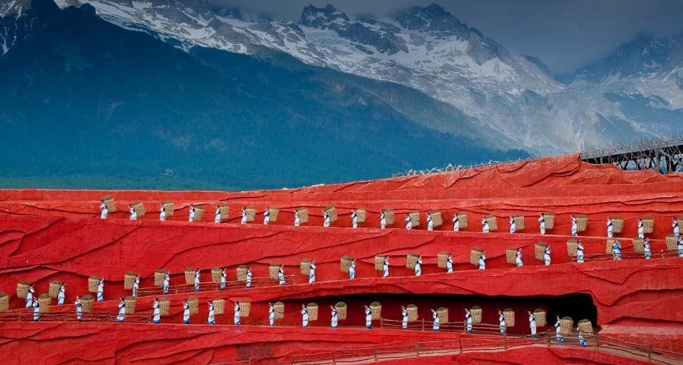 Folk dance performance in front of Jade Dragon Snow Mountain in Lijiang, Yunnan, China