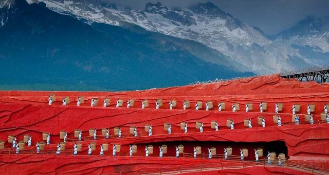 Folk dance performance in front of Jade Dragon Snow Mountain in Lijiang, Yunnan, China