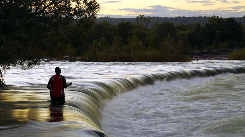 Man fishes in the Ord River at Kununurra, Western Australia 
