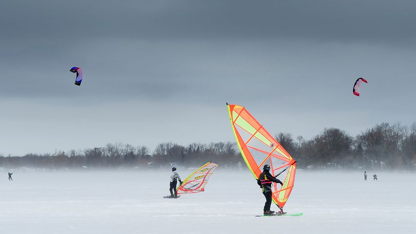 Wind surfers and snow kiters on frozen lake in Keswick, Ontario 