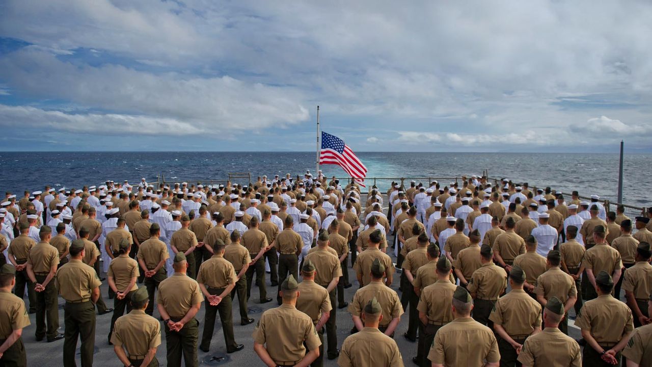 Marines and sailors aboard the USS Pearl Harbor dock landing ship during the 2011 ceremony commemorating the 70th anniversary of the attack on Pearl Harbor