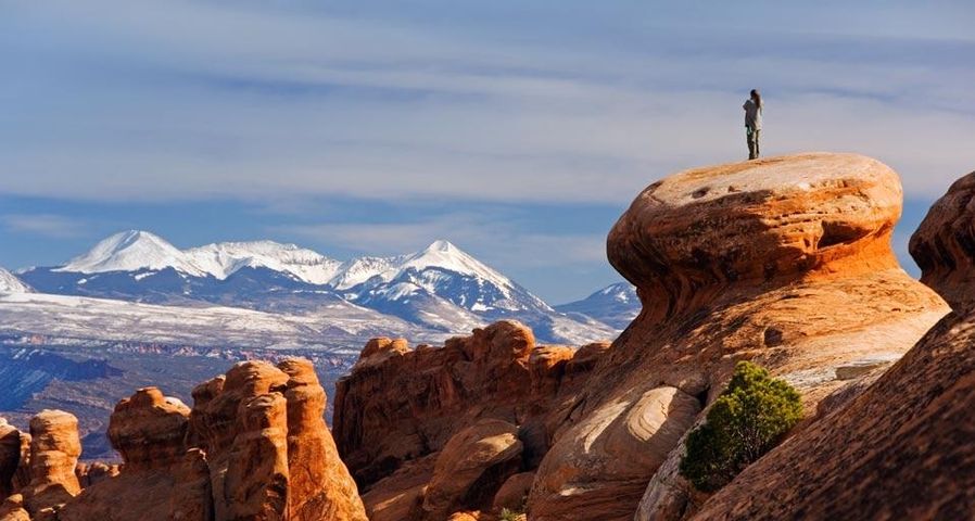 The snow-capped La Sal Mountains behind sandstone pinnacles at Devils Garden in Arches National Park, Utah