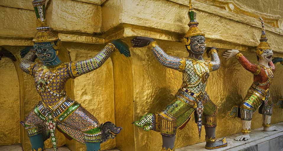 Mythical creatures guarding the golden chedi at the Grand Palace ...