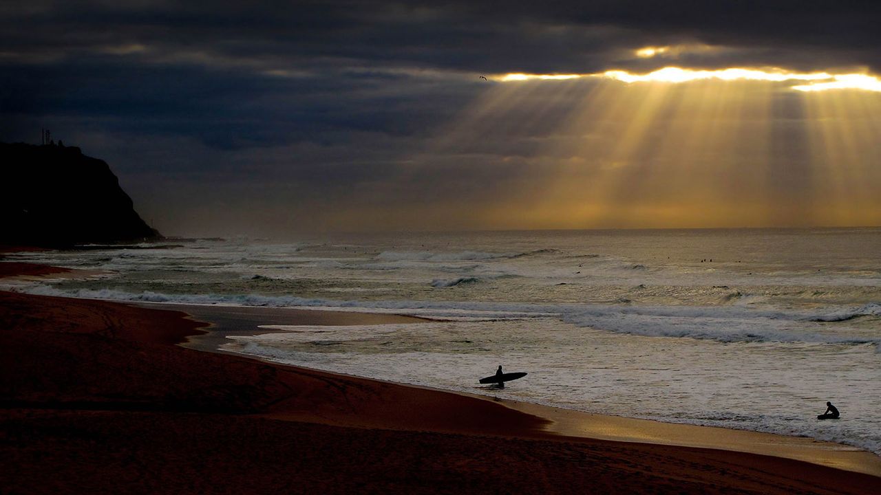 Surfers at Bar Beach near Newcastle, New South Wales 