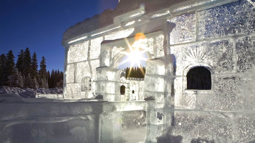 Ice castle with a sunburst and blue sky, Lake Louise, Alberta