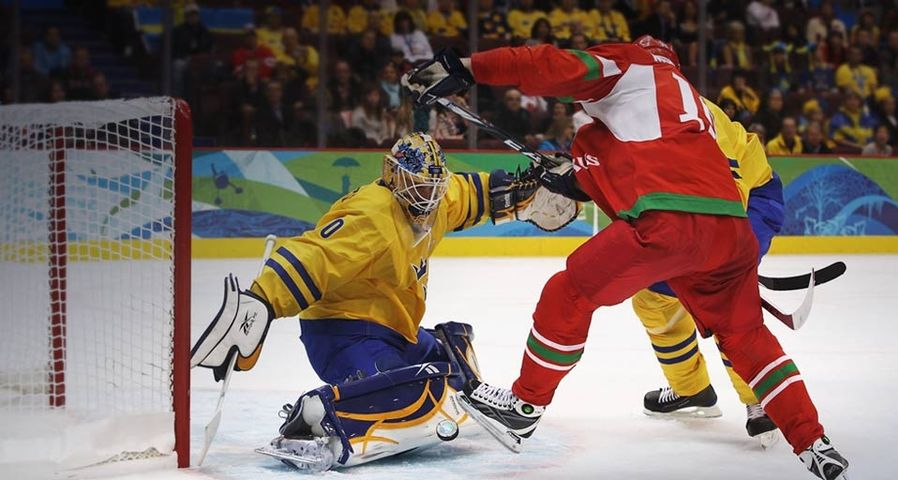 Goalkeeper Jonas Gustavsson of Sweden makes a save against Dmitri Meleshko of Belarus during the Men’s Ice Hockey preliminary game at the Vancouver 2010 Winter Olympics on February 19, 2010