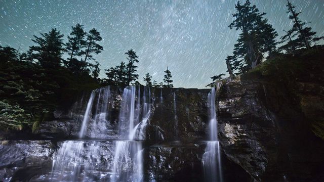 Tsusiat Falls at night, spilling onto the beach along the West Coast Trail, B.C.