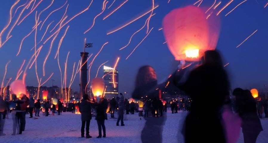 Long-exposure photograph of people launching paper lanterns on International Women's Day, St. Petersburg, Russia