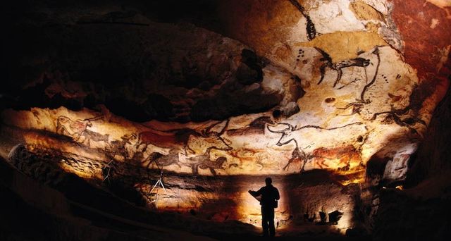 Paintings of Paleolithic bulls and other animals crowd calcite walls of the Lascaux caves in southwestern France