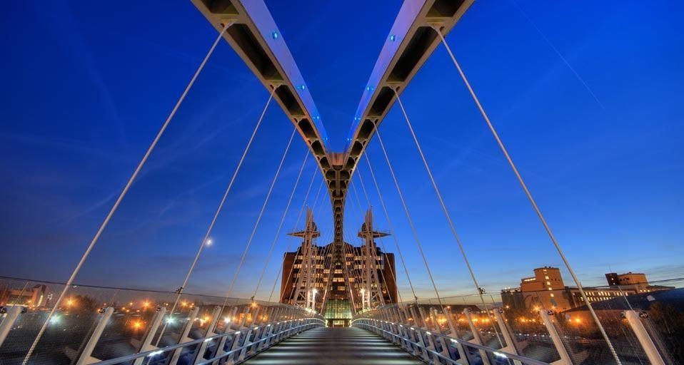 Lowry pedestrian suspension footbridge at dusk, Salford Quays, Manchester, England