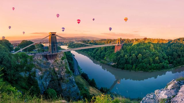 Hot air balloons over Clifton Suspension Bridge at sunrise, Bristol