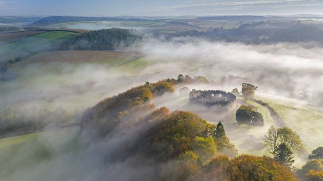 Autumn mist above Restormel Castle in Cornwall