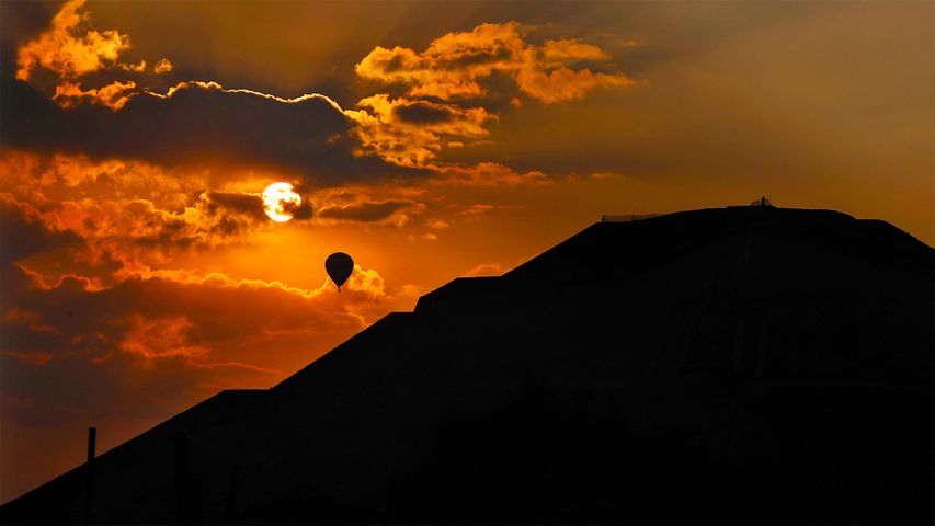 A balloon flies over the Pyramid of the Sun at sunrise in Teotihuacan, Mexico