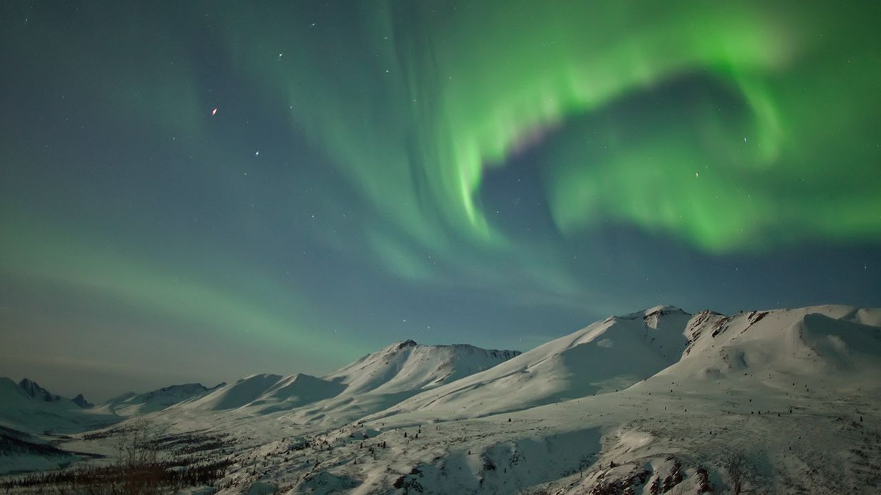 Aurora borealis dances over the Klondike Valley in Tombstone Territorial Park, Yukon 