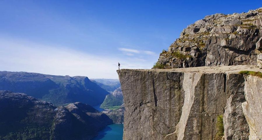 Man standing on Preikestolen Pulpit Rock, Lysefjord, Norway