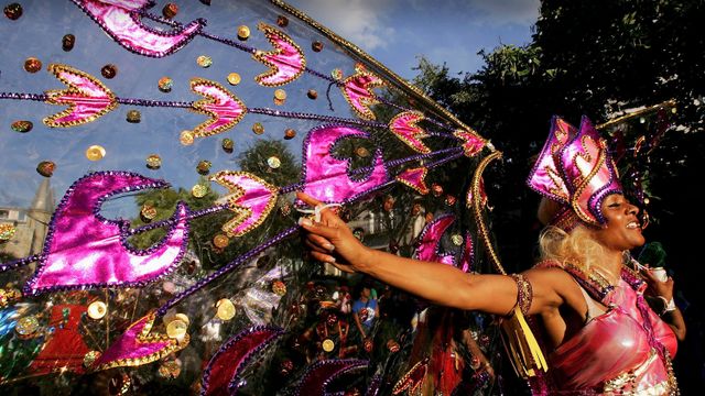 Mas performers in costume perform at the Notting Hill Carnival, London
