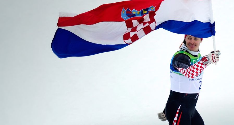 Croatia's silver medalist Ivica Kostelic celebrates with his national flag after the flower ceremony of the Men's Slalom race at the Vancouver 2010 Winter Olympics on February 27, 2010