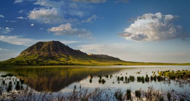 Bear Butte reflects into Bear Butte Lake near Sturgis, South Dakota