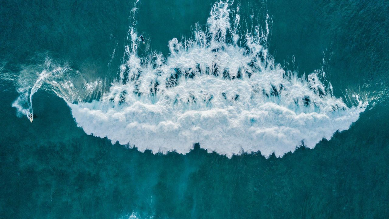 Aerial view of surfer catching a wave, Tenerife, Canary Islands, Spain 