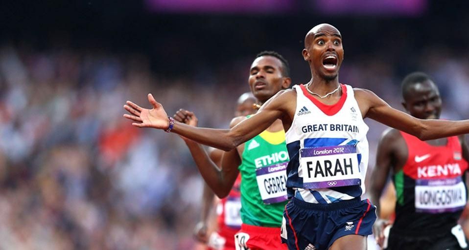 Mo Farah crosses the finish line to win gold in the Men's 5000m Final, London, England