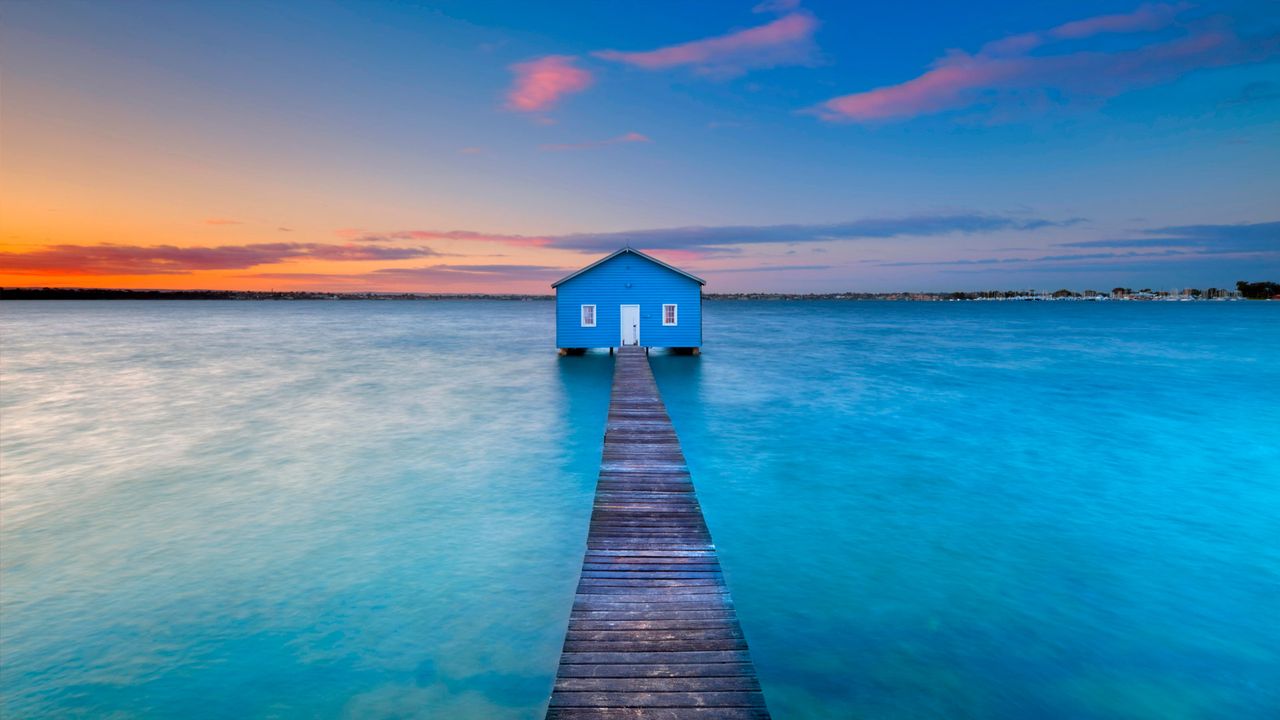 Sunrise over the Matilda Bay boathouse in the Swan River, Perth