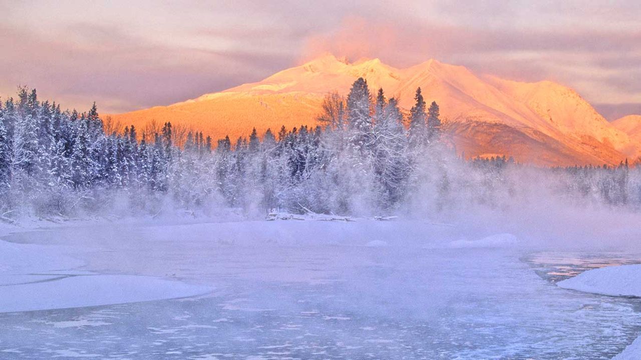 Bulkley River with an alpenglow and a frosty snowy, ice filled river at Telkwa, B.C. 