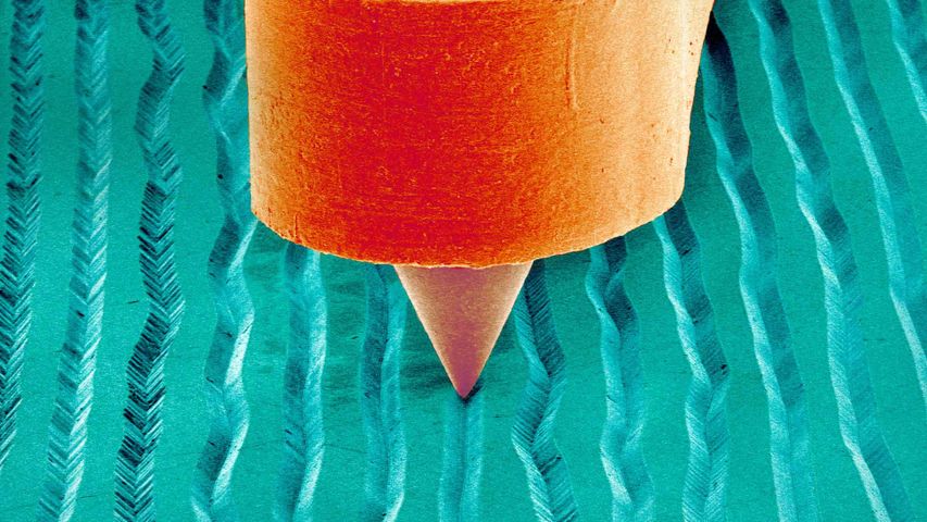 Rasterelektronenmikroskop-Aufnahme einer Nadel in der Rille einer Schallplatte. Anlässlich der Grammy Awards
