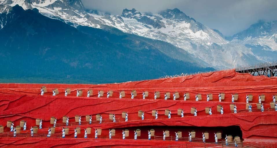 Folk dance performance in front of Jade Dragon Snow Mountain in Lijiang, Yunnan, China