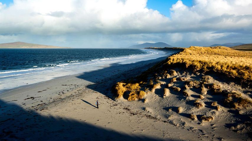 Woman walks on west beach, Berneray, Outer Hebrides, Scotland